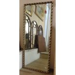 A 20th Century moulded gilt framed bevelled oblong wall mirror