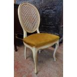 A pair of French style parcel gilt framed boudoir chairs with rattan backs and upholstered seats -