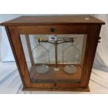 A vintage glazed oak vitrine by Eureka Scientific Co., Ilford containing a set of laboratory