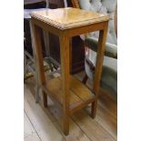 A 15" early 20th Century oak two tier stand, set on square tapered supports
