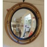 An antique style gilt and ebonised framed convex wall mirror - several beads missing
