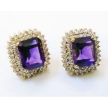 A pair of high carat yellow metal ear-rings, each set with large oblong amethyst within a diamond