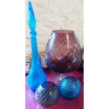 An oversized amethyst glass brandy balloon - sold with a blue bubble glass decanter and two