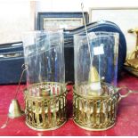 A pair of chamber sticks with glass shades and snuffers
