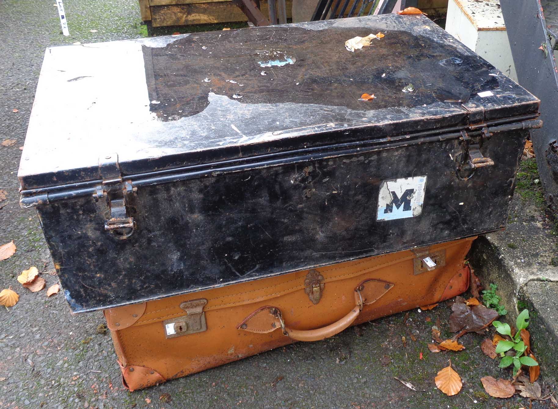 A tin trunk with contemporary labels - sold with a fibreboard suitcase