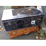 A tin trunk with contemporary labels - sold with a fibreboard suitcase