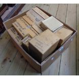 A box containing a large quantity of clock spares including platform escapements, new movement,