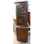 A reproduction mahogany corner cabinet with glazed top and cupboard under