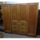 A 6' 11 1/2" Victorian mahogany break-front wardrobe/press with central linen slides over chest of