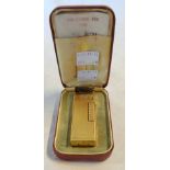 A cased vintage gilt metal Dunhill Rollagas lighter, initialled J.D.C