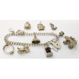 A silver and white metal charm bracelet - sold with four loose charms
