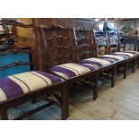 A set of six antique mahogany framed Georgian style pierced ladder back dining chairs with