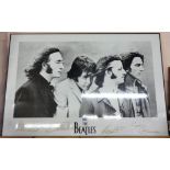 A large framed monochrome photograph poster on board of The Beatles with facsimilie signatures