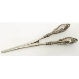 A pair of silver handled glove stretchers