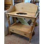 A 30 1/2" Victorian waxed pine washstand with splash back and bowl aperture to top, turned front