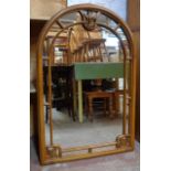 A 3' 5" high modern decorative polished wood framed dome top wall mirror with applied beading and