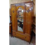 A 3' 9" early 20th Century walnut wardrobe with hanging space enclosed by a shaped bevelled mirror