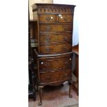 A 24" early 20th Century mahogany and cross banded bow front chest on chest with decorative