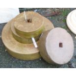 Four sharpening stones of varying diameter, the largest 17"