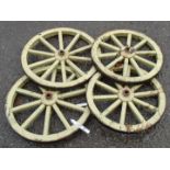 A set of four iron rimmed wooden cart wheels - two 16" diameter the others 14"