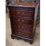 A reproduction media cabinet in the form of a four drawer chest