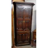 A 3' 3" 19th Century stained oak corner cupboard with shaped shelves enclosed by a pair of