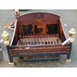 A cast iron fire basket with brass finials by Oakhill