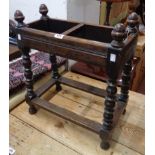 An early 20th Century polished stained oak stick stand with acorn finials to bobbin turned supports