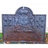 A 36 1/2" antique cast iron fire back with central Royal coat of arms dated 1662 and flanking