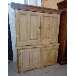 A 5' Victorian stripped pine two part larder cupboard with moulded cornice and shelves enclosed by