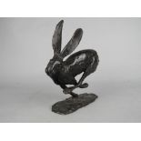 PAUL JENKINS (B.1949), Running Hare, a limited edition bronze sculpture on an oval base, No.26/65,