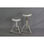 A PAIR OF INDUSTRIAL MACHINIST STYLE SWIVEL STOOLS, on triple wavy legs, approximate max height 69cm