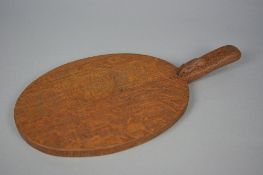 A ROBERT THOMPSON 'MOUSEMAN' OF KILBURN OAK OVAL CHEESE BOARD, the mouse carved to the handle,