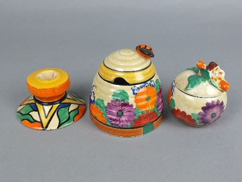 A CLARICE CLIFF BIZARRE GAY DAY HONEY POT, in the form of a skep, bee shaped knop to lid, printed