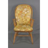 AN ERCOL ELM AND BEECH SPINDLE BACK WINDSOR ARMCHAIR, with original floral cushions to seat and