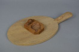 A ROBERT THOMPSON 'MOUSEMAN' OF KILBURN OAK OVAL CHEESE BOARD, the mouse carved to the handle,
