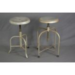 AN INDUSTRIAL MACHINIST STYLE SWIVEL STOOL, on four legs united by stretcher and a similar stool