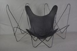 A METAL FRAMED BUTTERFLY STYLE CHAIR, with removable upholstery and two spare frames (3)