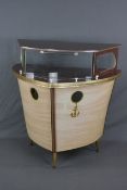 A 1950'S COCKTAIL BAR, formed as a ship on three raised tapering legs with electrical wiring,