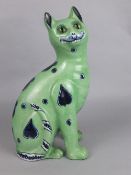 AN EARLY 19TH CENTURY FAIENCE POTTERY SEATED CAT, of Galle/Mosanic style, green ground with blue and