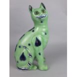 AN EARLY 19TH CENTURY FAIENCE POTTERY SEATED CAT, of Galle/Mosanic style, green ground with blue and