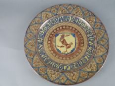 A LATE 19TH CENTURY CIRCULAR EARTHENWARE CHARGER, hand painted with pink lustre and blue decoration,