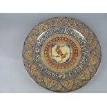 A LATE 19TH CENTURY CIRCULAR EARTHENWARE CHARGER, hand painted with pink lustre and blue decoration,