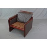 A DYRLUND DANISH ARMCHAIR, rosewood finish, with brown leather back and sides (missing one cushion)