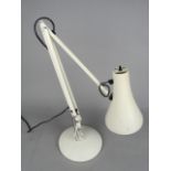 A CREAM ANGLE POISE STYLE DESK LAMP, on a circular base