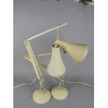 TWO CREAM HERBERT TERRY & SONS LTD ANGLE POISE DESK LAMPS, on circular bases (s.d.)