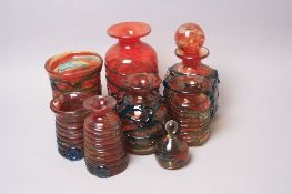 A GROUP OF ORANGE MDINA GLASS VASES, all with an applied blue ribbon trail and a small orange