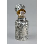 A LATE VICTORIAN SILVER SCENT BOTTLE, Chester 1899, with stopper, repousse floral and foliate scroll