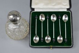 A CASED SILVER COFFEE SPOON SET, and a silver topped scent bottle