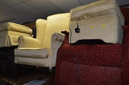 A GOLD UPHOLSTERED WINGED ARMCHAIR WITH TWO SIMILAR FOOTSTOOLS (3)